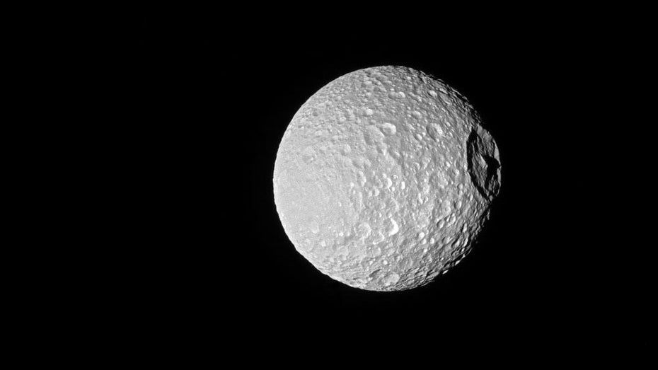 Der eigentümliche Herschel-Krater, der den besonderen Look von Eismond Mimas ausmacht, erstreckt sich über eine Breite von 139 Kilometern – fast ein Drittel des Durchmessers von Mimas selbst. (Bild: NASA/JPL-Caltech/Space Science Institute) Der eigentümliche Herschel-Krater, der den besonderen Look von Eismond Mimas ausmacht, erstreckt sich über eine Breite von 139 Kilometern - fast ein Drittel des Durchmessers von Mimas selbst. (Bild: NASA/JPL-Caltech/Space Science Institute)